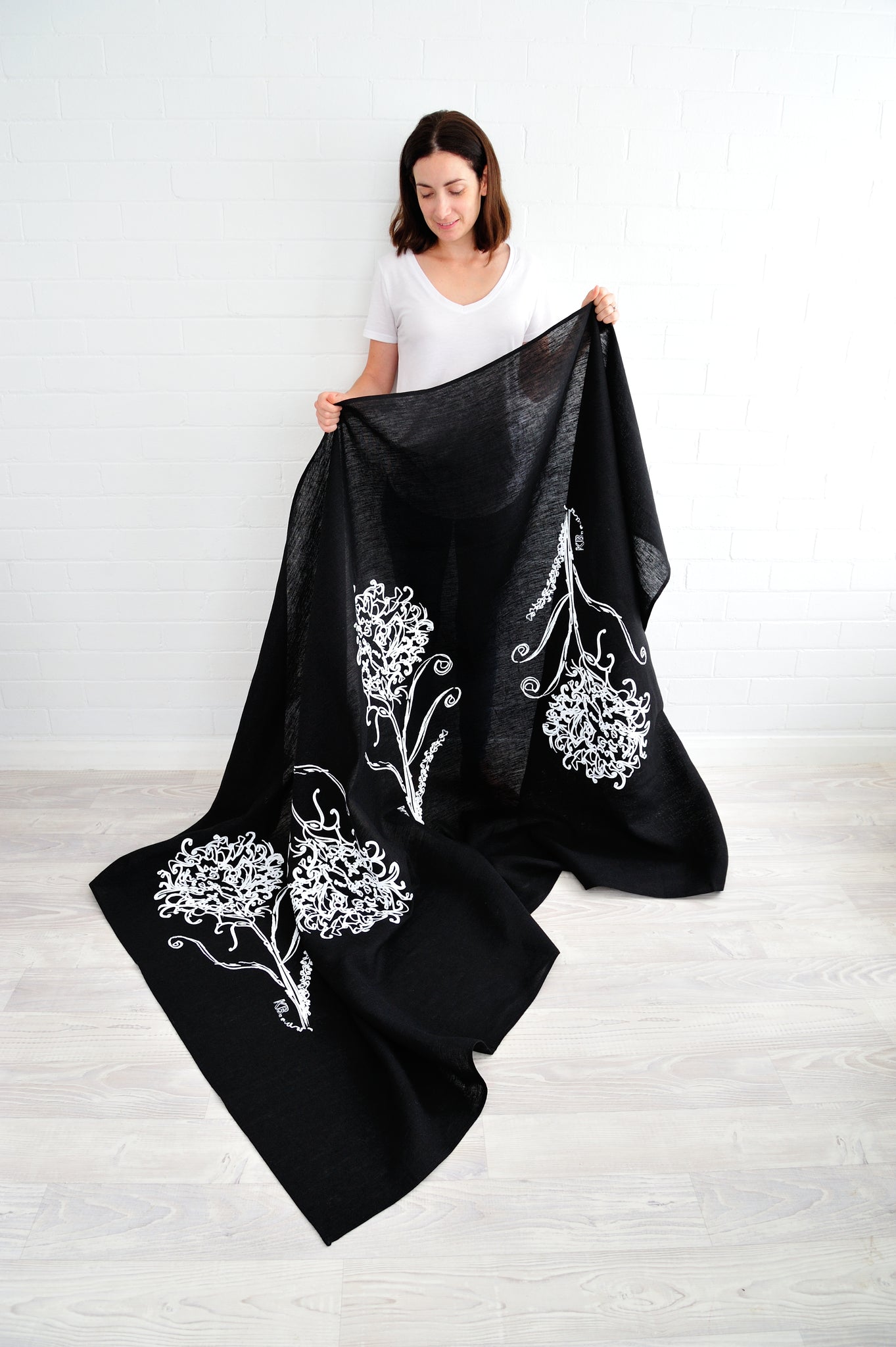 100% linen hand screen printed white waratah on black tablecloth by Krystol Brailey Designs
