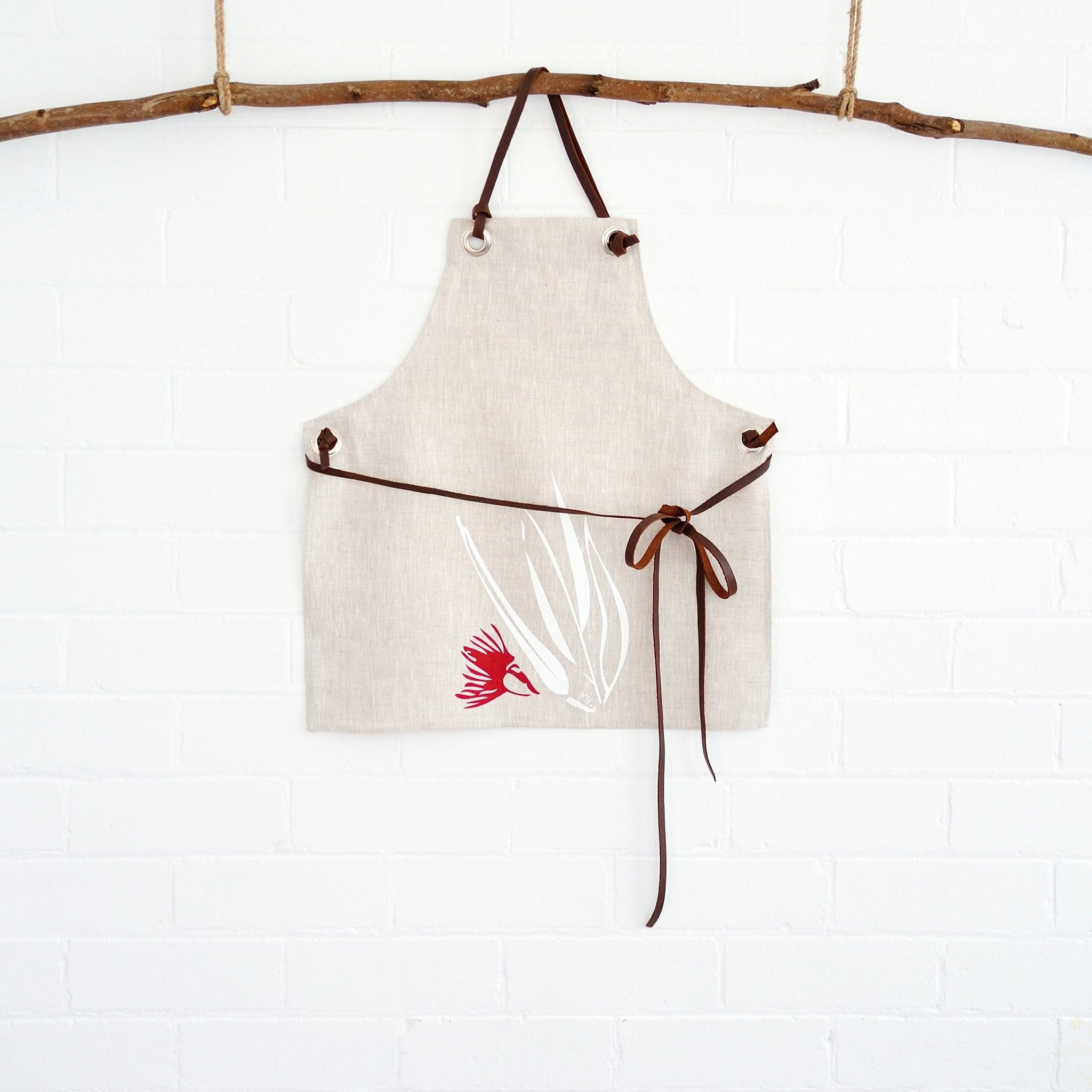 100% linen hand screen printed red and white gum nut kids apron with leather straps by Krystol Brailey Designs